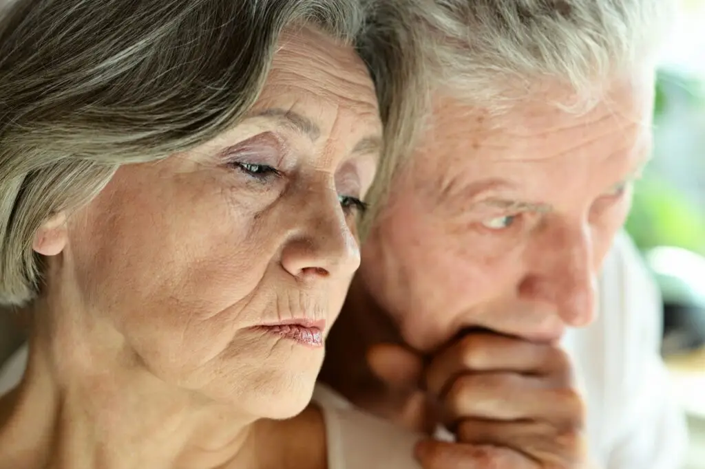 Elderly man and woman appearing thoughtful, possibly facing memory loss or cognitive impairment.